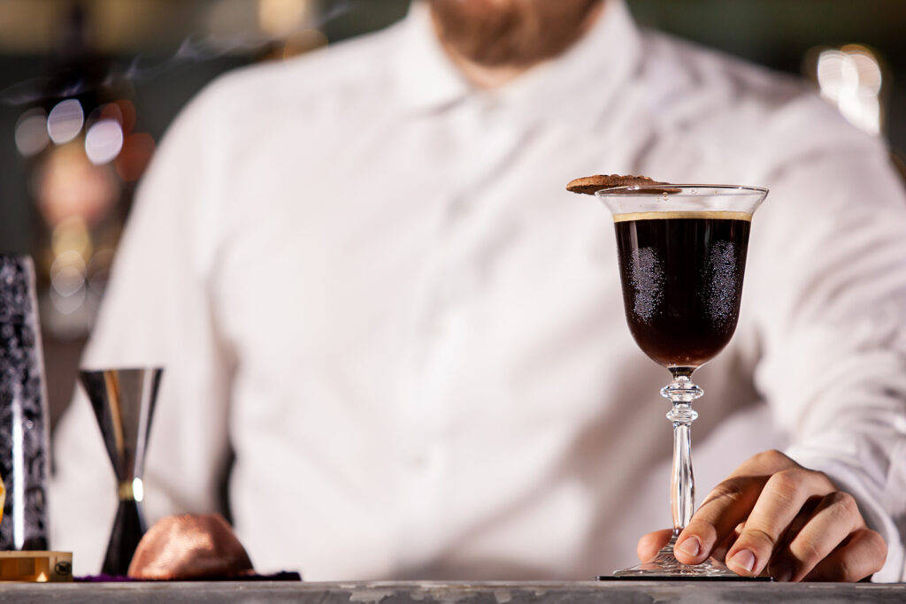 Bartenderpresenting coffe cocktail in lounge bar